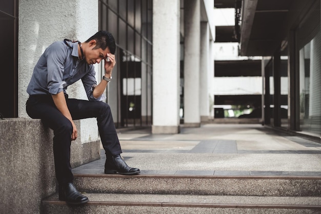 Unemployed man sitting on the street