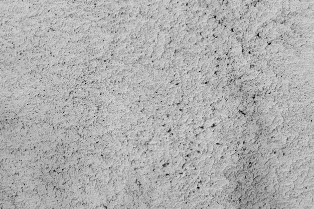 Uneven gray surface. Abstract gray background. Gray stucco texture. Dark rough surface.