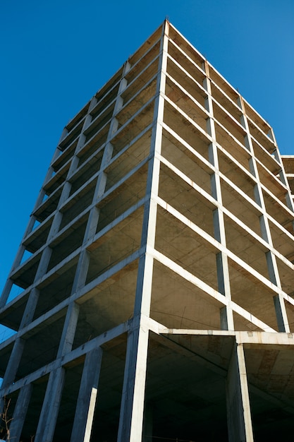 Unfinished cement building at a construction site in the summer