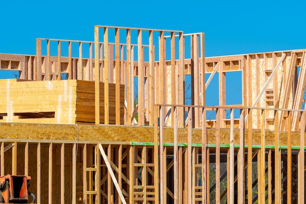 Unfinished plywood house against the blue sky