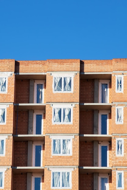 Unfinished tall building against the blue sky