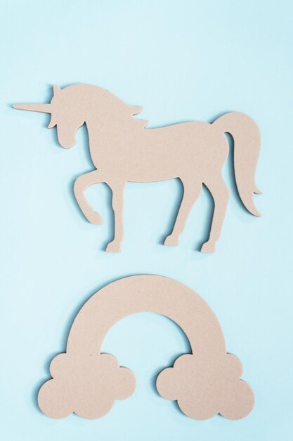 Unfinished unicorn cut out on blue background.