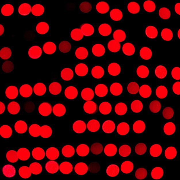 Unfocused abstract red bokeh on black background. defocused and blurred many round light.