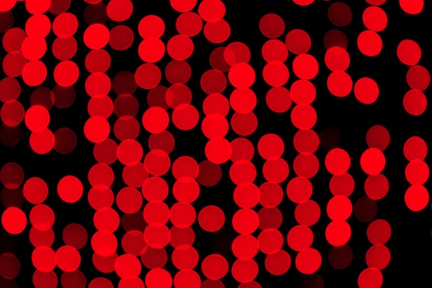 Unfocused abstract red bokeh on black background defocused and blurred many round light