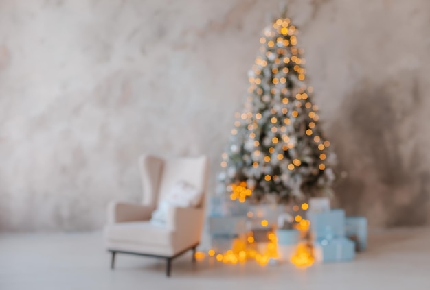 Unfocused silhouette of a Christmas tree with blurred lights. Background for congratulations new year 2020. Free space for text.