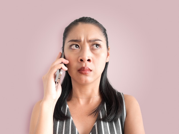 Unhappy and angry  Asian woman talking phone call on smartphone.