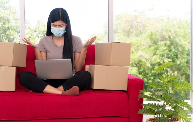 Unhappy Asian young entrepreneur on a mask Tired expression And fed up with problems in doing business at home office