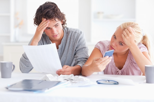 Unhappy couple doing accounts