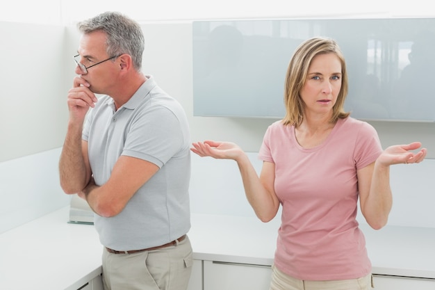 Unhappy couple having an argument in kitchen