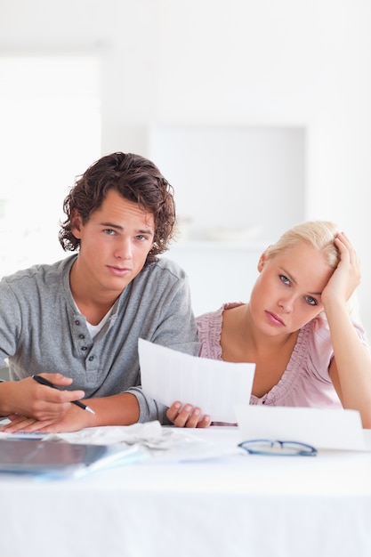 Unhappy couple reading a letter