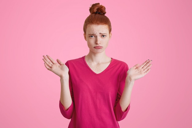 Unhappy displeased female model with hair bun