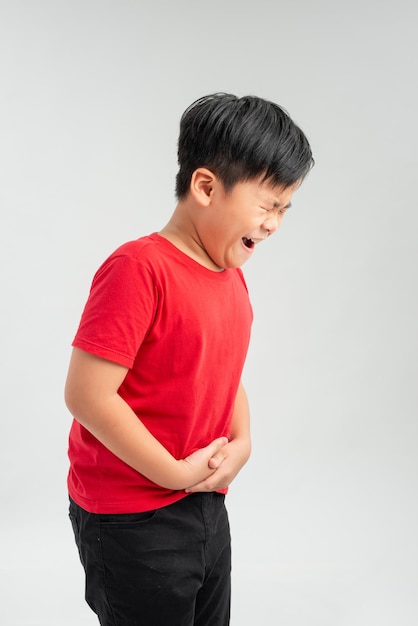 Unhappy Little boy showing stomach pain