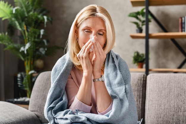 Unhappy mature lady caught cold or suffering from seasonal allergy