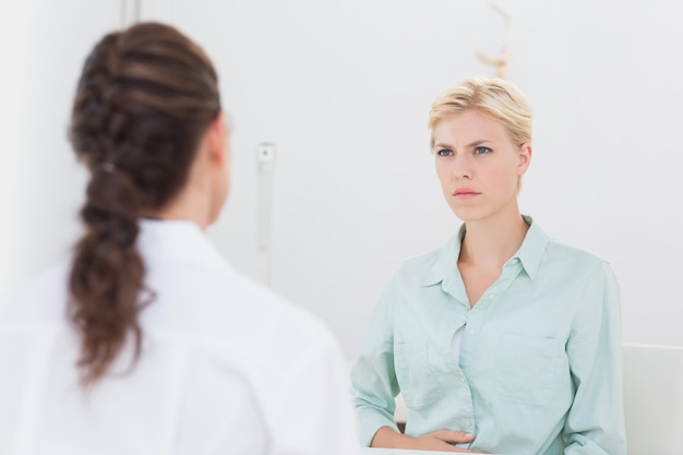 unhappy patient speaking with doctor 