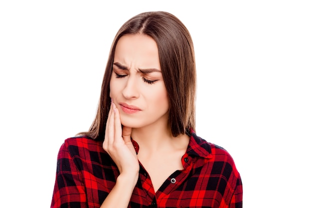 Unhappy sick woman having toothache and touching cheek