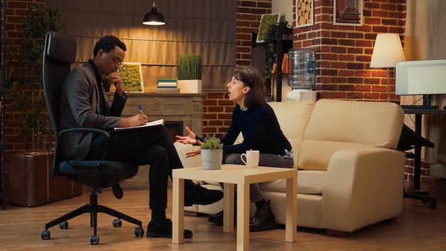 Unhappy woman complaining about relationship conflict and problems, talking about husband and asking for help. Psychology advisor listening to patient at couple therpay session.