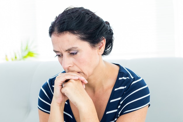 Unhappy woman sitting on the couch