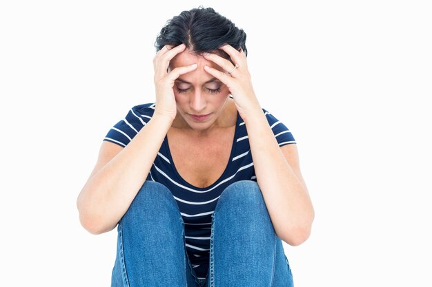 Unhappy woman sitting on the floor