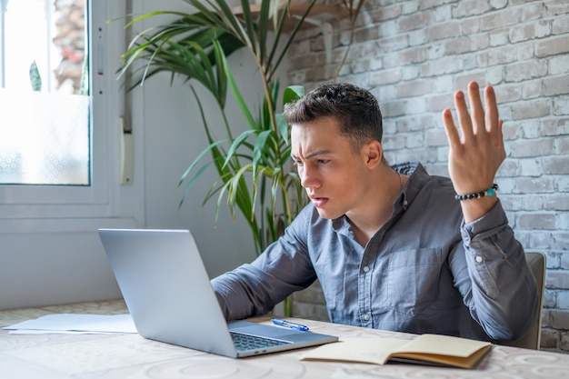 unhappy young caucasian male worker in glasses look at laptop screen shocked by gadget breakdown or operational problems frustrated man confused surprised by unexpected error on computer devicexa