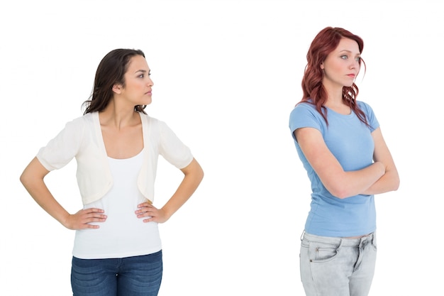 Unhappy young female friends not talking after argument