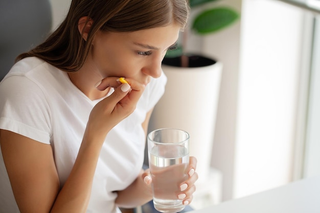 Unhappy young worker suffering from aching teeth in the office