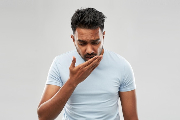 unhealthy indian man coughing