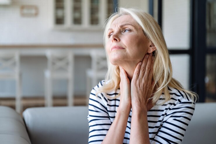 Unhealthy mature woman touching lymph nodes feeling painful sensations