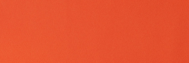 Unicolorous bright orange fabric as background close up of orange textile