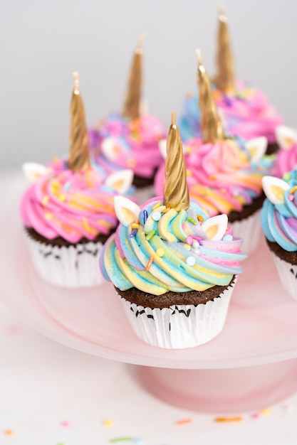 Unicorn cupcakes decorated with colorful buttercream icing and sprinkles.