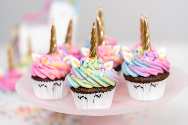 Unicorn cupcakes decorated with colorful buttercream icing and sprinkles.