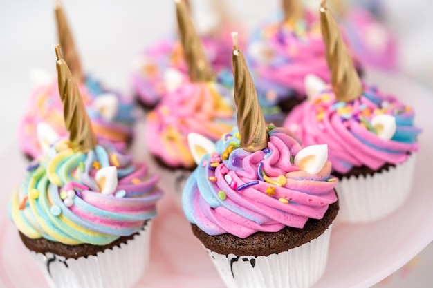 Unicorn cupcakes decorated with colorful buttercream icing and sprinkles.