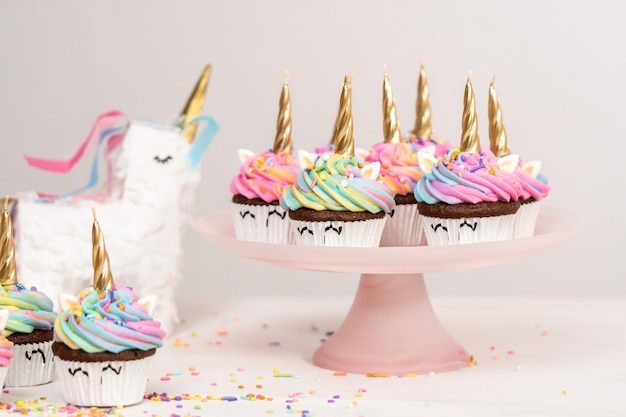 Unicorn cupcakes decorated with colorful buttercream icing and sprinkles.