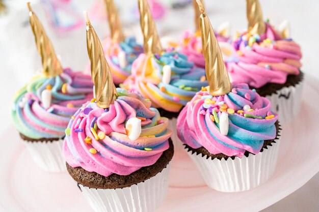 Unicorn cupcakes decorated with colorful buttercream icing and sprinkles.