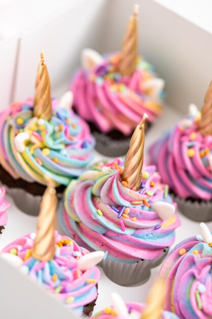 Unicorn cupcakes in a white cupcake box.