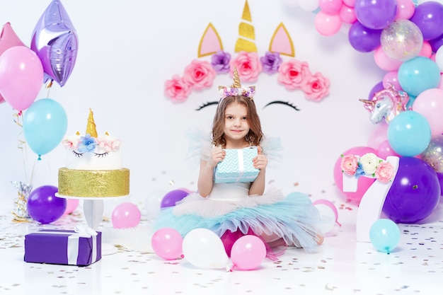 Unicorn girl holding gift box at the birthday party