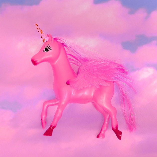 Unicorn toy in the pink sky. Dreams concept