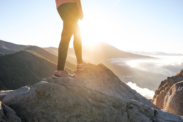 Unidentified woman watching the sunset on the mountain