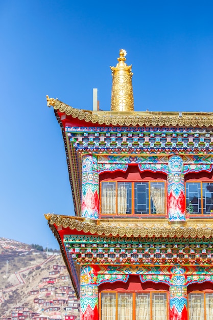 Unique architecture in the colorful windows of tibetan style on red wall