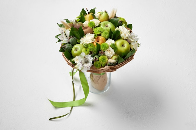 Unique green bouquet of fruits and flowers as a gift