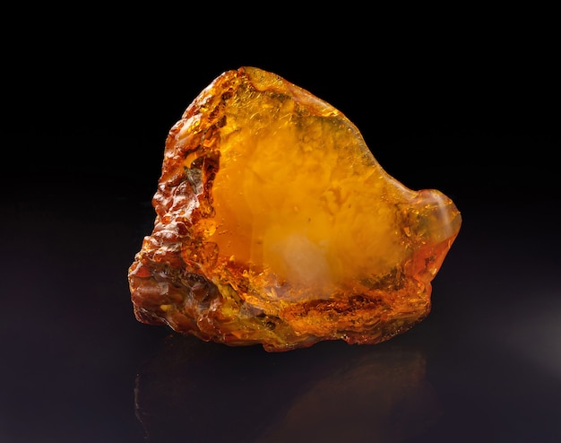 A unique piece of solar amber on black