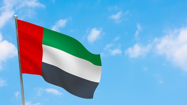 United arab emirates flag on pole. Blue sky. National flag of United arab