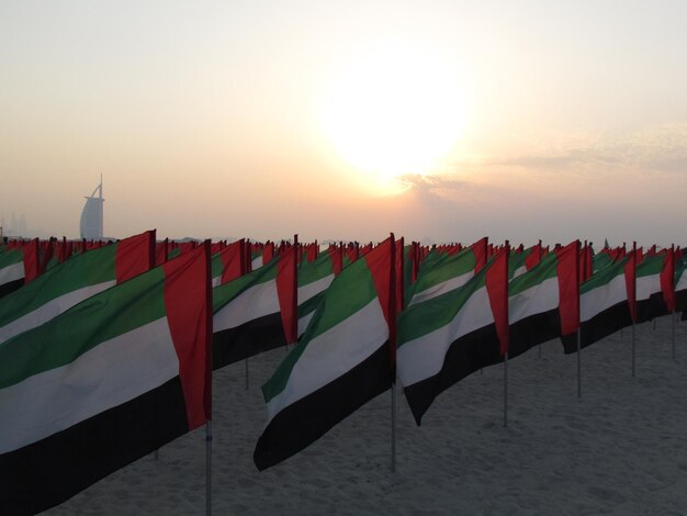 Photo united arab emirates flags on sand against sky