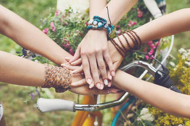 United hands of girls in the park