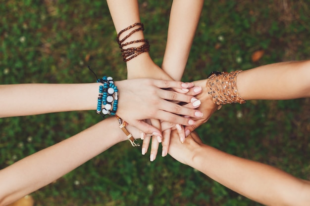 United hands of girls in the park