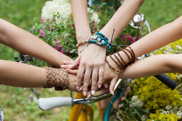 United hands of girls in the park