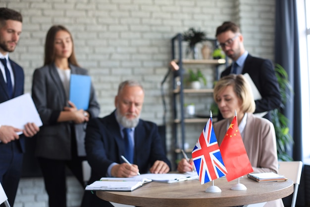 United Kingdom and Chinese leaders signing a document.