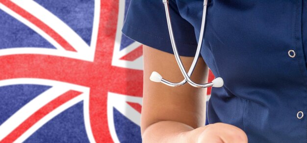 United Kingdom flag female doctor with stethoscope, national healthcare system