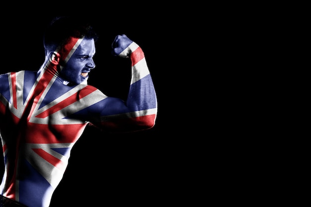 United Kingdom flag on handsome young muscular man black background