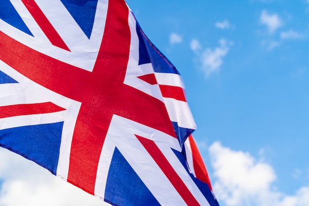 United Kingdom Flag waving on wind in blue sky