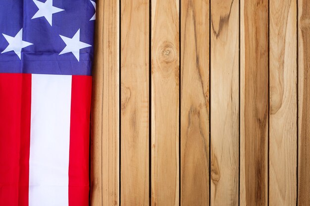 United states of america flag on wooden table background. usa
holiday of veterans, memorial, independence ( fourth of july) and
labor day concept